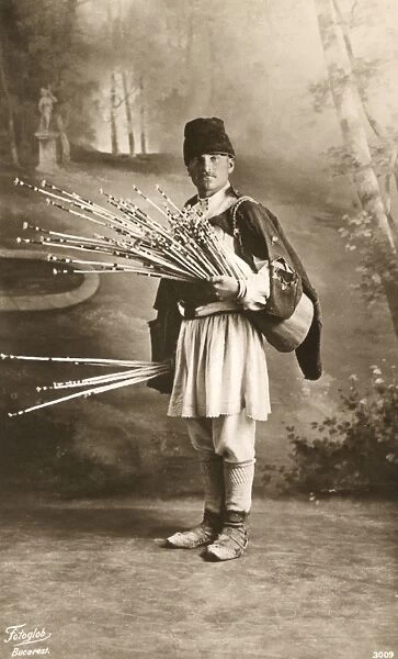 Romanian man with bunch of thin sticks