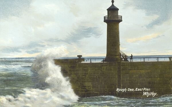 Rough sea hitting the East Pier at Whitby, Yorkshire