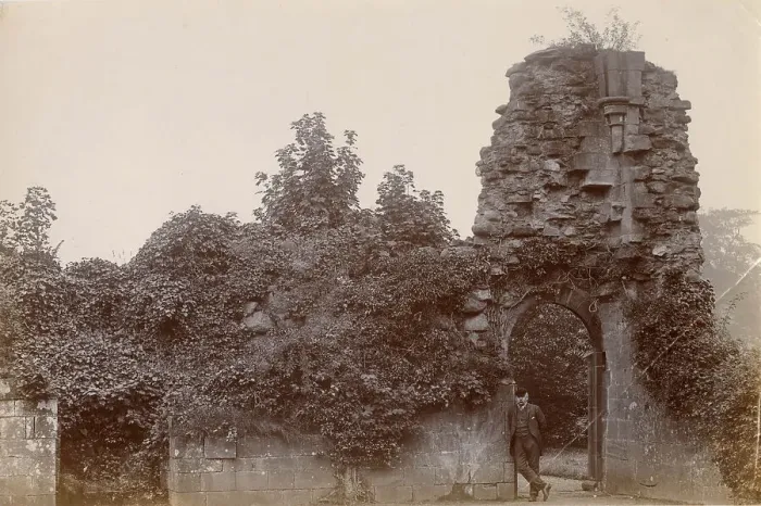 Framed Print : Ruined medieval building, North Wales, with man leaning in open doorway Date: circa 1889 Framed Print : Ruined medieval building, North Wales, with man leaning in open doorway Date: circa 1889