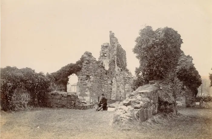 Framed Print : Ruined medieval building, North Wales, with smartly dressed seated man Date: circa 1889 Framed Print : Ruined medieval building, North Wales, with smartly dressed seated man Date: circa 1889