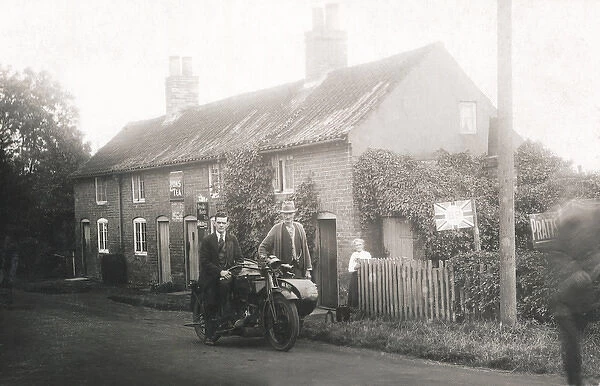Rural scene showing veteran motorcycle combination & cottage