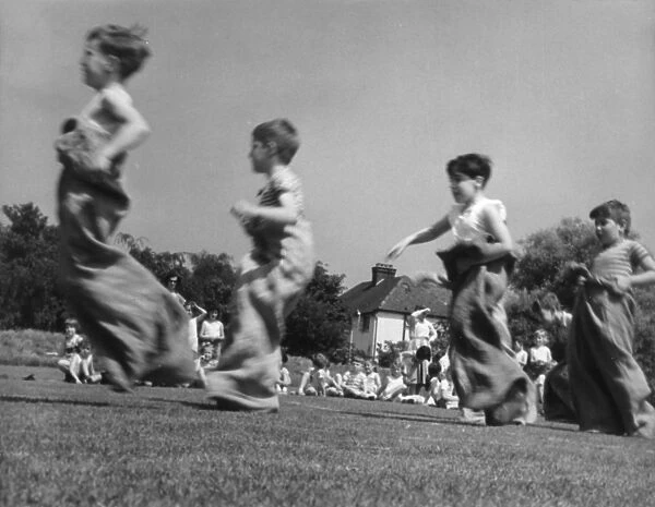SACK RACE. Children compete in a sack race, during a school sports day