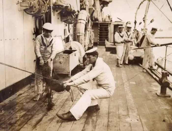 Framed Print : Sailor binding a swab, sitting on a rope, WW1 Framed Print : Sailor binding a swab, sitting on a rope, WW1