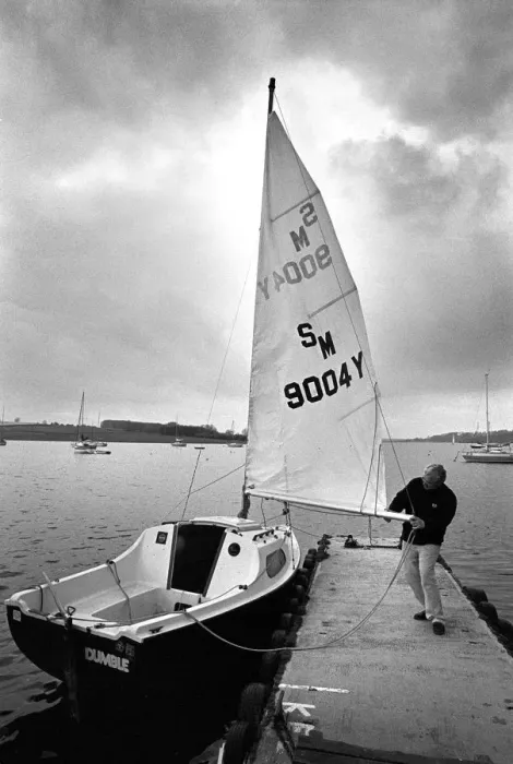 Framed Print : A sailor prepares his small yacht for a sail on Rutland Wate Framed Print : A sailor prepares his small yacht for a sail on Rutland Wate