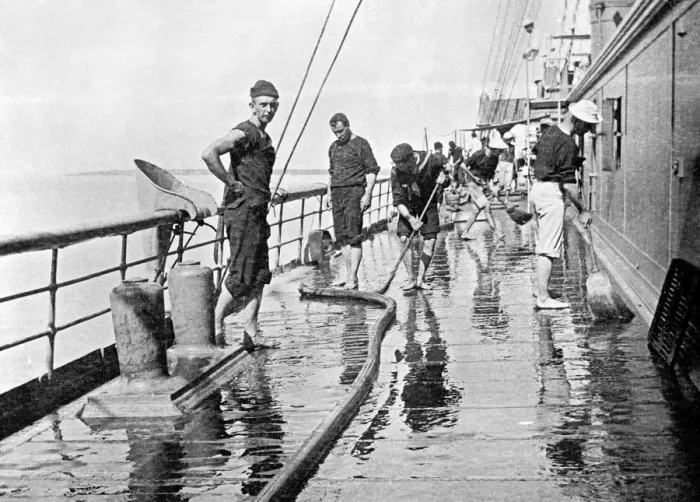 Framed Print : Sailor washing down decks on the U. S. S. Yankee
