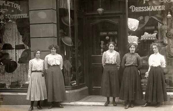 Sales assistants outside a dress shop