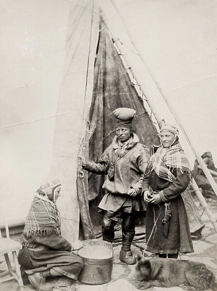 Sami people and their dog outside a tent Finnmarken, Norway