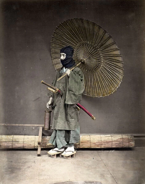 Samuari in winter clothes, and umbrella, Japan