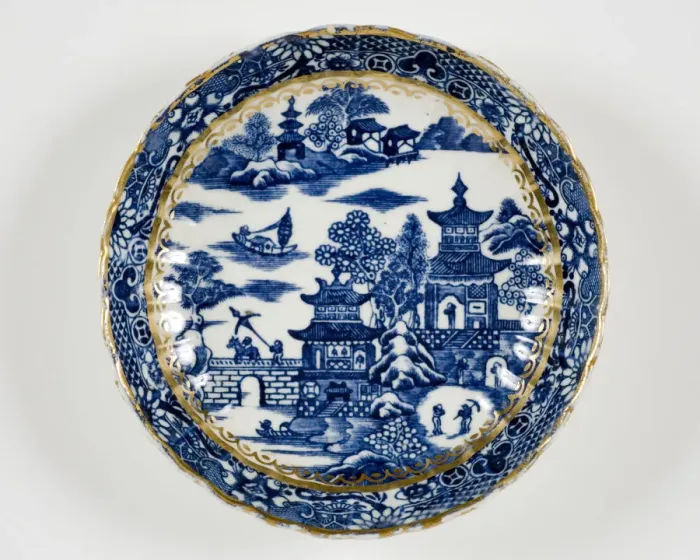 Framed Print : Saucer made from porcelain, transfer-printed in underglaze blue with the Framed Print : Saucer made from porcelain, transfer-printed in underglaze blue with the