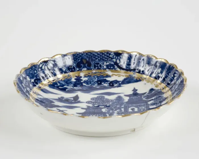 Framed Print : Saucer made from porcelain, transfer-printed in underglaze blue with the Framed Print : Saucer made from porcelain, transfer-printed in underglaze blue with the