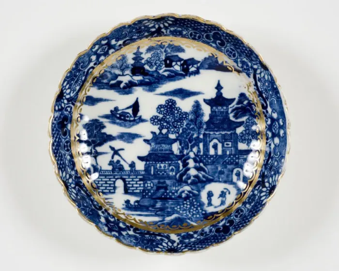 Framed Print : Saucer made from porcelain, transfer-printed in underglaze blue with the Framed Print : Saucer made from porcelain, transfer-printed in underglaze blue with the