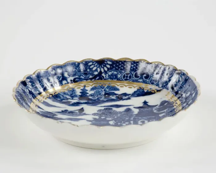 Framed Print : Saucer made from porcelain, transfer-printed in underglaze blue with the Framed Print : Saucer made from porcelain, transfer-printed in underglaze blue with the