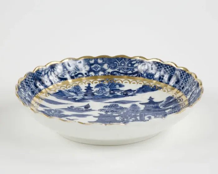 Framed Print : Saucer made from porcelain, transfer-printed in underglaze blue with the Framed Print : Saucer made from porcelain, transfer-printed in underglaze blue with the