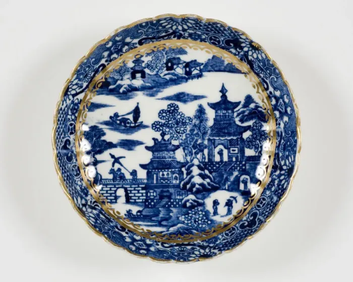 Framed Print : Saucer made from porcelain, transfer-printed in underglaze blue with the Framed Print : Saucer made from porcelain, transfer-printed in underglaze blue with the