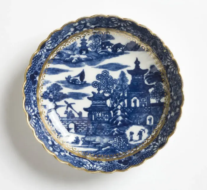 Framed Print : Saucer made from porcelain, transfer-printed in underglaze blue with the Framed Print : Saucer made from porcelain, transfer-printed in underglaze blue with the