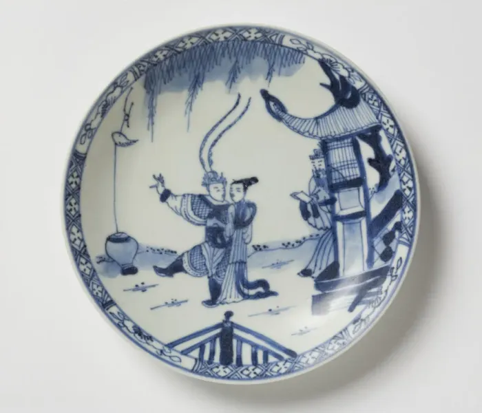 Framed Print : Saucer. Porcelain saucer with cobalt blue underglaze decoration of three figures Framed Print : Saucer. Porcelain saucer with cobalt blue underglaze decoration of three figures