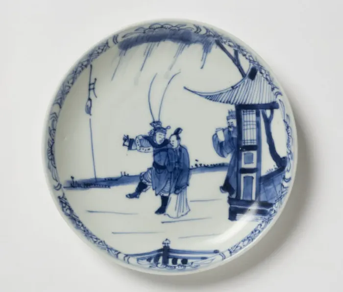 Framed Print : Saucer. Porcelain saucer with cobalt blue underglaze decoration of three figures