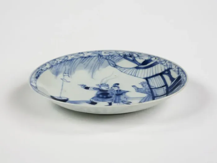 Framed Print : Saucer. Porcelain saucer with cobalt blue underglaze decoration of three figures Framed Print : Saucer. Porcelain saucer with cobalt blue underglaze decoration of three figures