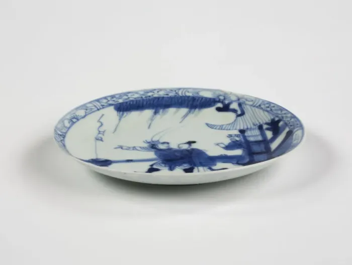 Framed Print : Saucer. Porcelain saucer with cobalt blue underglaze decoration of three figures Framed Print : Saucer. Porcelain saucer with cobalt blue underglaze decoration of three figures