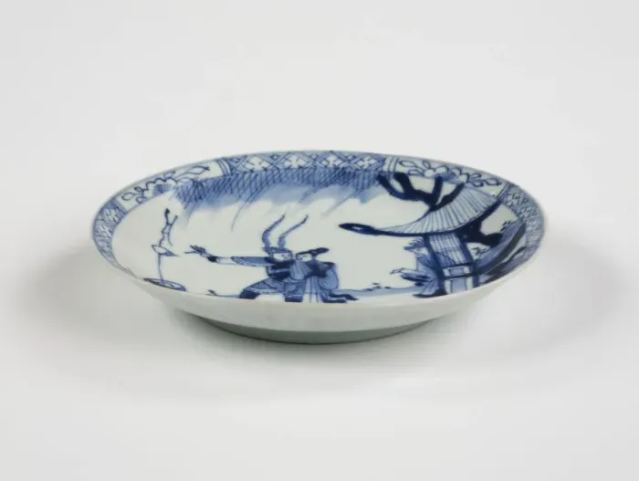 Framed Print : Saucer. Porcelain saucer with cobalt blue underglaze decoration of three figures Framed Print : Saucer. Porcelain saucer with cobalt blue underglaze decoration of three figures