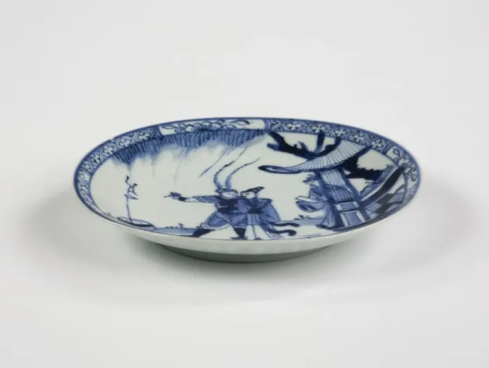 Framed Print : Saucer. Porcelain saucer with cobalt blue underglaze decoration of three figures Framed Print : Saucer. Porcelain saucer with cobalt blue underglaze decoration of three figures