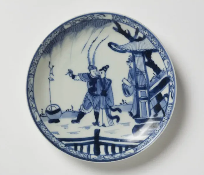 Framed Print : Saucer. Porcelain saucer with cobalt blue underglaze decoration of three figures Framed Print : Saucer. Porcelain saucer with cobalt blue underglaze decoration of three figures