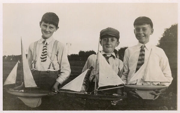 Three schoolboys and their model yachts