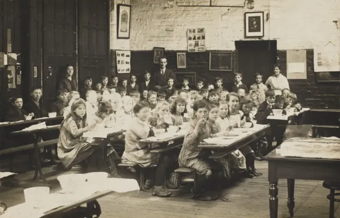 Framed Print : Schoolchildren ear their midday meal at their desks. Date: early 20th century Framed Print : Schoolchildren ear their midday meal at their desks. Date: early 20th century