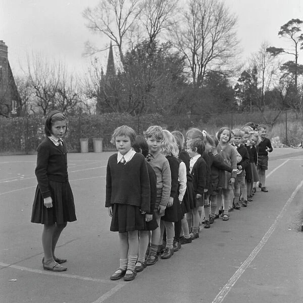 Schoolchildren line up in playground