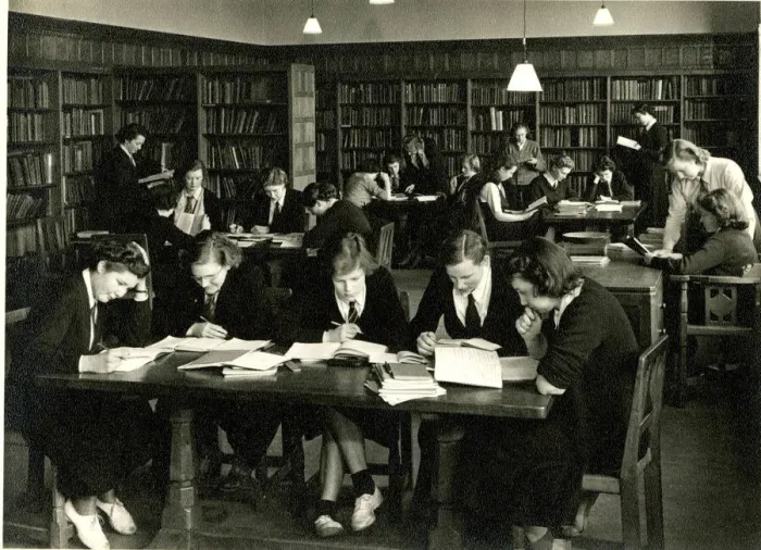 Framed Print : Schoolgirls in uniform studying in a library Framed Print : Schoolgirls in uniform studying in a library