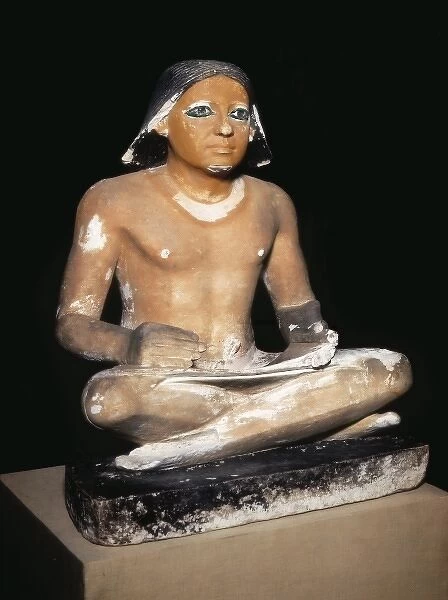 Scribe seated cross-legged holding a papyrus