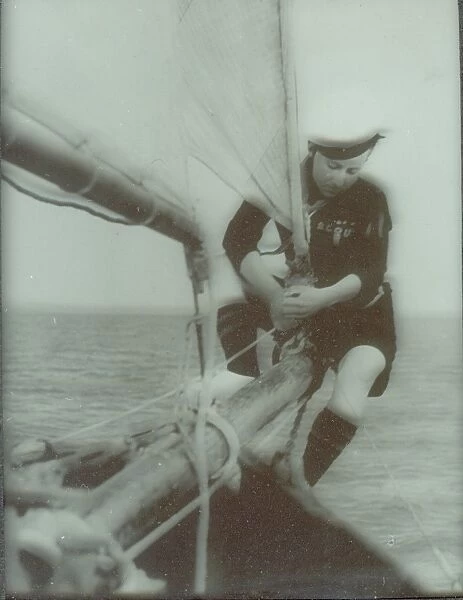 Sea Scout sitting on boom of sail