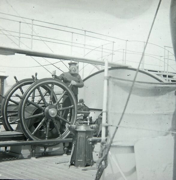Seaman at the wheel of a ship