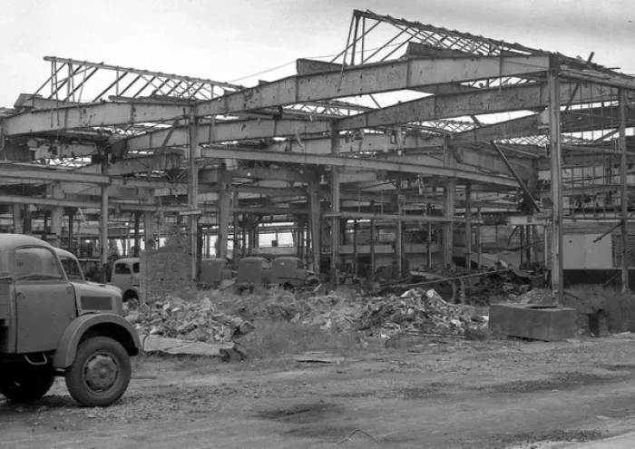 Framed Print : Shell of a building with parked vehicles Framed Print : Shell of a building with parked vehicles