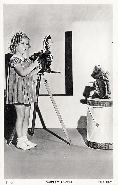 Shirley Temple photographing her teddy bear on a postcard