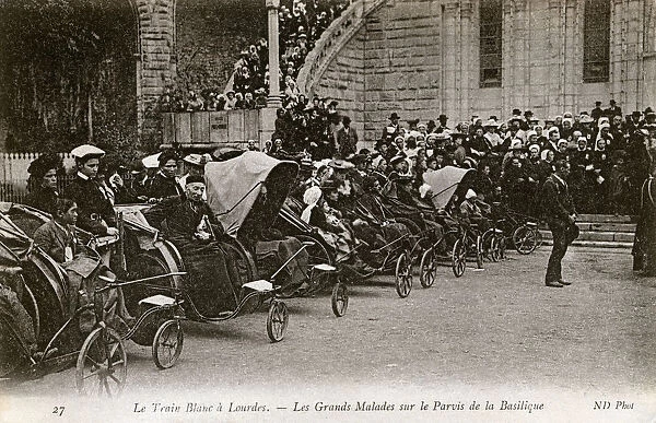 The sick in Bath chairs by the Basilica, Lourdes, France