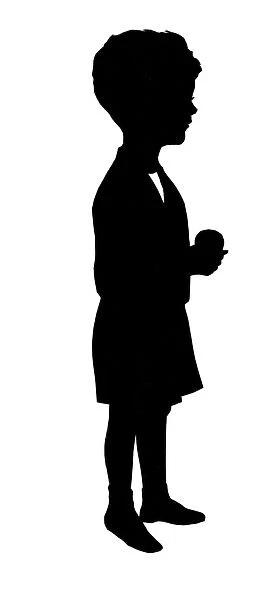 Silhouette of boy with apple