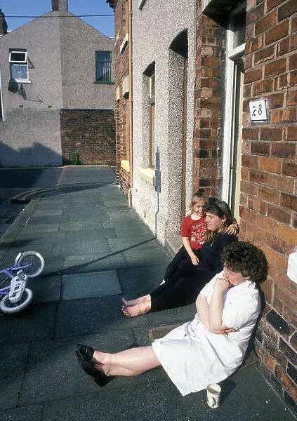 Sitting on the pavement outside a house in Barrow in Furness