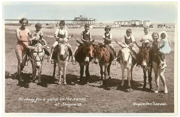 Skegness, Lincolnshire: six children on donkeys, ready for a gallop on the sands Date: 1937