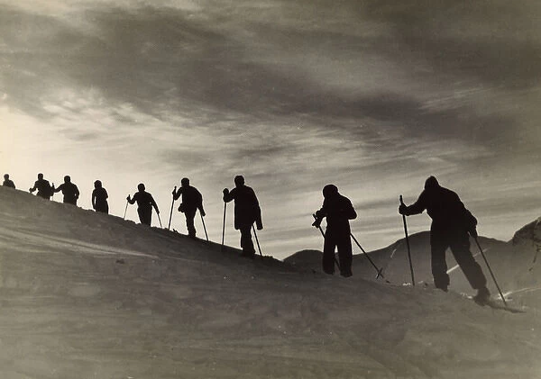 Skiers Climbing Hill
