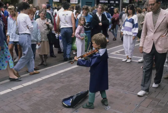 Framed Print : Small boy busking with his violin for an audience in Dublin Framed Print : Small boy busking with his violin for an audience in Dublin