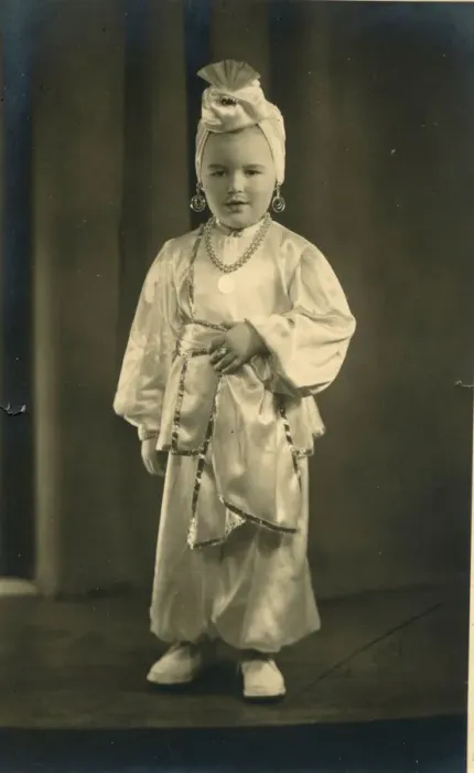 Framed Print : A small boy (or girl) dressed in a turban and harem pants in an Arabian Nights style