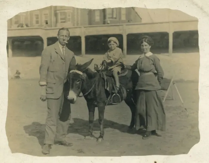 Framed Print : A small child goes for a donkey ride on the beach at an unidentified British seaside Framed Print : A small child goes for a donkey ride on the beach at an unidentified British seaside