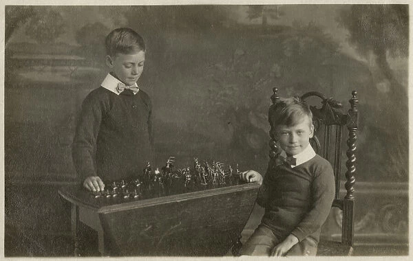 Two smart young boys play with their model tin soldiers