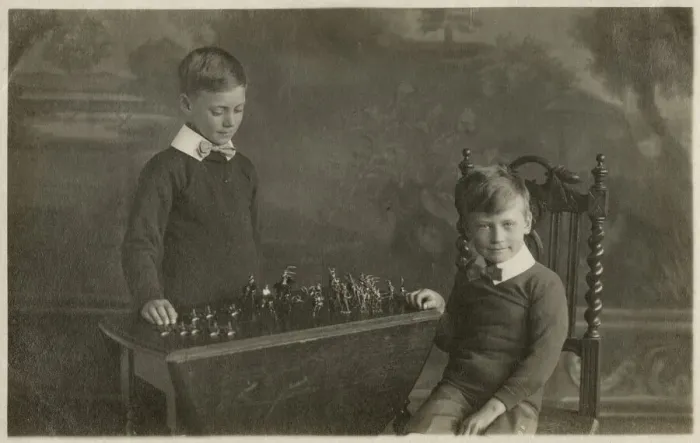 Framed Print : Two smart young boys play with their model tin soldiers