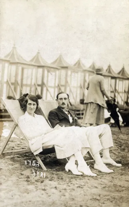 Framed Print : Smart young couple sat on the beach in deckchairs Framed Print : Smart young couple sat on the beach in deckchairs