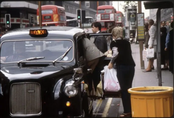Framed Print : Two smartly dressed women pile into a London black taxi cab, after a spot of shopping on Oxford Street. Date: 1981 Framed Print : Two smartly dressed women pile into a London black taxi cab, after a spot of shopping on Oxford Street. Date: 1981