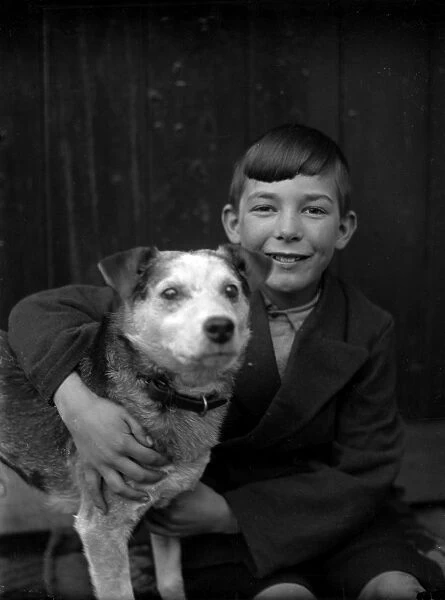 A smiling boy and his terrier dog