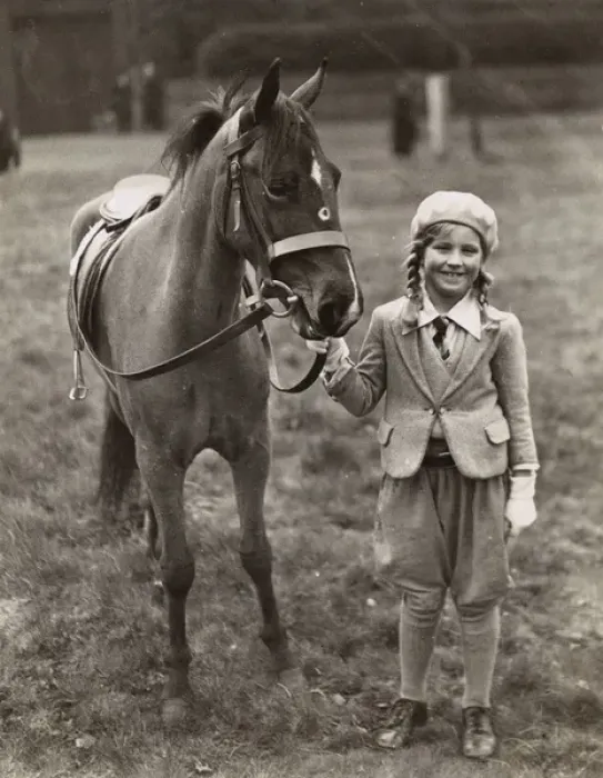 Framed Print : Smiling girl with her pony in a field Framed Print : Smiling girl with her pony in a field