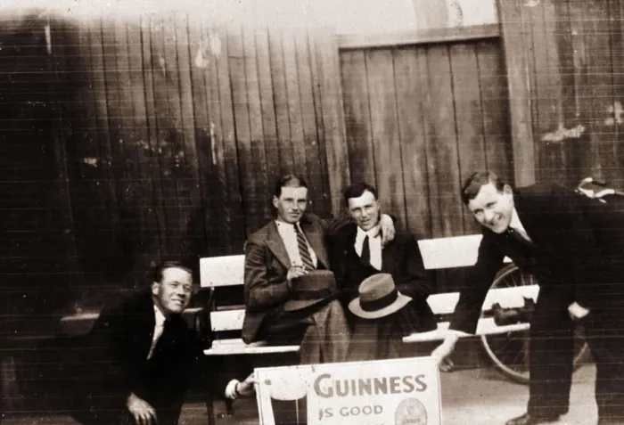 Framed Print : Four smiling men with Guinness advert Framed Print : Four smiling men with Guinness advert